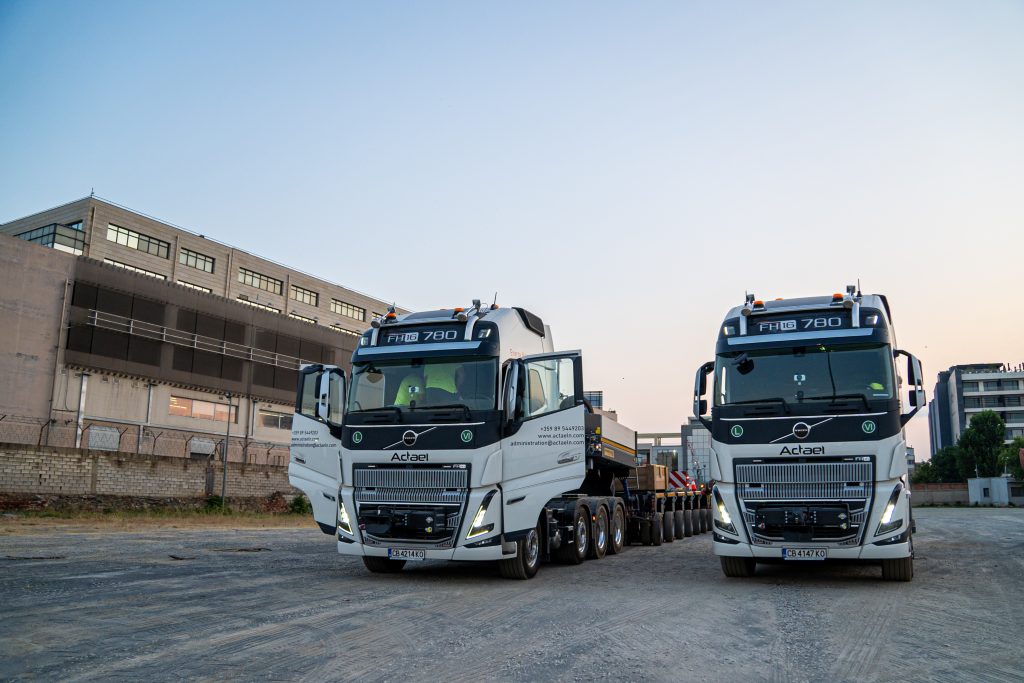 Team supervising oversized machinery movement on highway