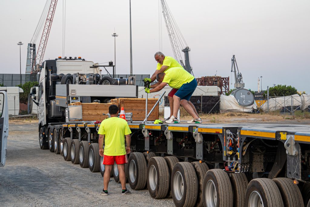 Excavator being loaded onto transport vehicle