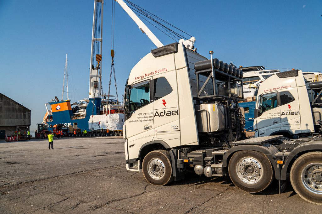 Heavy equipment loaded on flatbed trailer at worksite