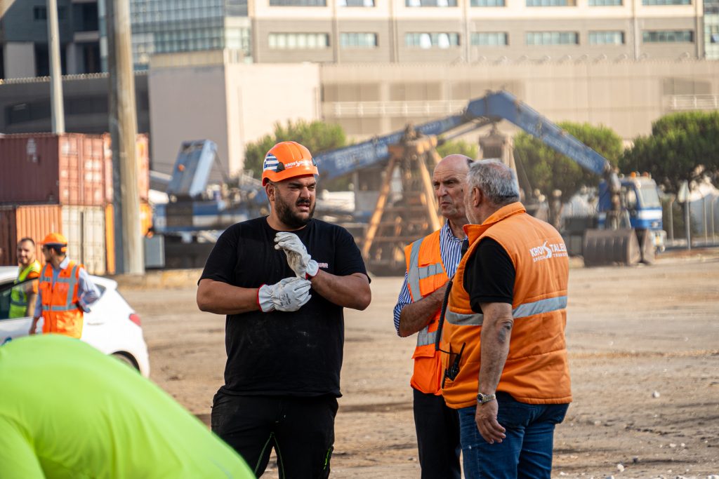 Modular building unit being craned onto transport truck
